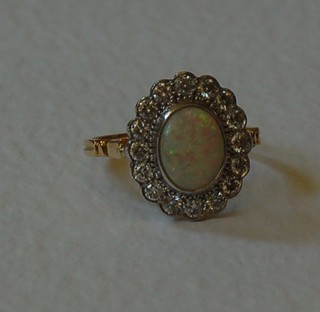 A lady's 18ct yellow gold dress ring set an oval cut opal surrounded by numerous diamonds approx 0.90ct