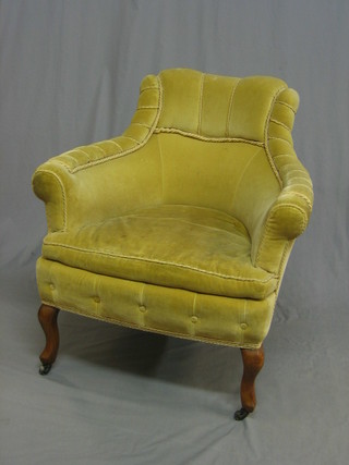 An Edwardian walnut framed armchair upholstered in yellow material