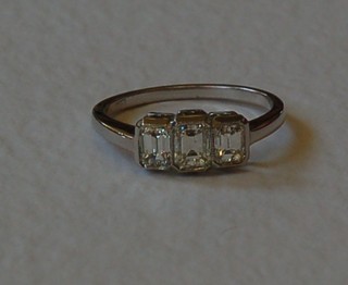 A lady's 18ct white gold dress ring set 3 rectangular cut diamonds, approx 1ct
