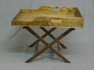 A butler's tray, raised on a folding stand 29"