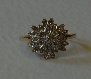A gold floral cluster ring set diamonds
