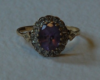 A 9ct gold cluster dress ring set an oval cut amethyst surrounded by diamonds