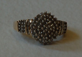 A gold cluster dress ring set diamonds