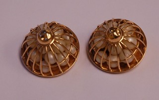 A pair of 14ct gold ear clips in the form of domed cages the interior containing numerous pearls, the reverse marked Levitan