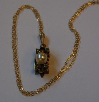 A 14ct gold pendant set pearls and 5 emeralds hung on a gold chain