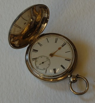 A silver pocket watch contained in a full hunter case