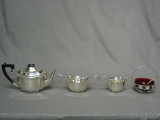 A silver plated 3 piece tea service comprising teapot, cream jug and sugar bowl and a silver plated jam dish with red glass liner 