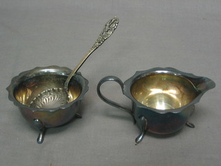 A silver plated cream jug and matching sugar bowl