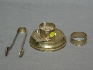 2 silver napkin rings, a silver ashtray and a pair of plated tongs