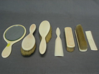 A 6 piece ivory backed dressing table set comprising a pair of hair brushes, pair of clothes brushes, shoe horn and hand mirror