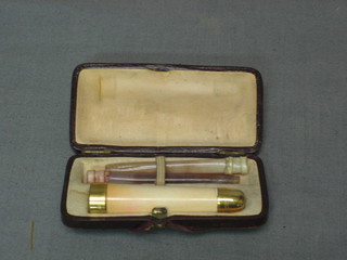 A cheroot holder with gilt metal mounts and 2 cigarette holders