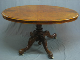 A Victorian oval figured walnut snap top Loo table, raised on a carved column 53"