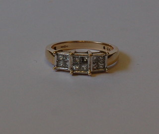 A lady's gold dress ring set 4 square cut diamonds within a square mount (approx 1/2 ct)