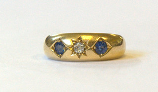 An 18ct gold dress ring set a diamond and 2 blue stones