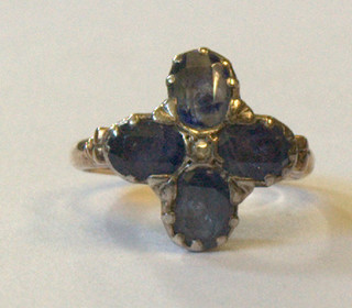 A gilt metal dress ring set 4 foil backed blue stones