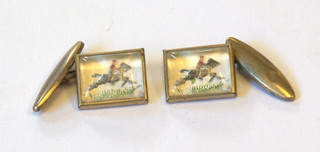 A pair of square crystal cufflinks decorated horse riders