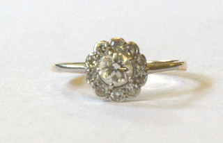 A gold cluster ring set large diamonds supported by 10 small diamonds