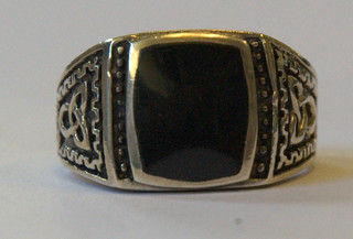 A gentleman's large silver signet ring set a black coloured stone