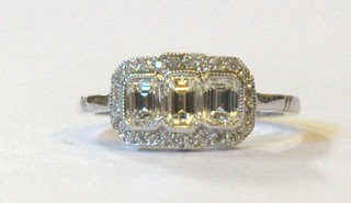 A lady's 18ct white gold dress ring set 3 lozenge  cut diamonds supported by numerous diamonds approx 1.15ct