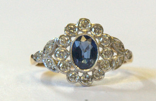 A lady's 18ct yellow gold dress ring set an oval cut sapphire surrounded by diamonds approx 0.55/0.90ct