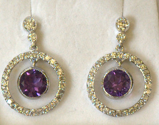 A pair of lady's 18ct white gold drop earrings set diamonds the centre set amethyst