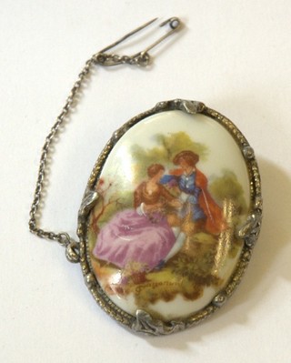 An oval Limoges porcelain brooch decorated a romantic scene