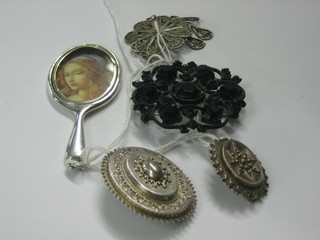 2 Victorian silver brooches, a filigree pendant, a pierced black metal brooch and a silver plated miniature hand mirror