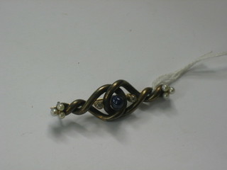 A "silver" bar brooch set a cabouchon cut moonstone supported by  2 white stones and having 6 demi-pearls