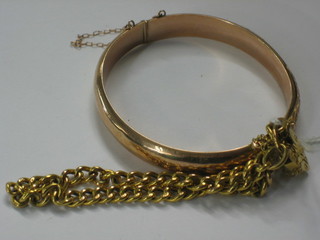 A 9ct gold curb link bracelet with padlock clasp and an engraved gilt metal bracelet