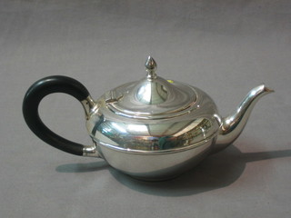 A circular silver plated teapot and a Queen Anne style engraved silver plated hotwater jug