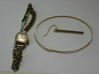 A lady's gold cased wristwatch, a pair of gilt metal earrings and a gilt metal bracelet (f)