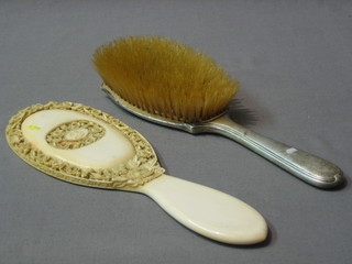 A carved ivory hand mirror