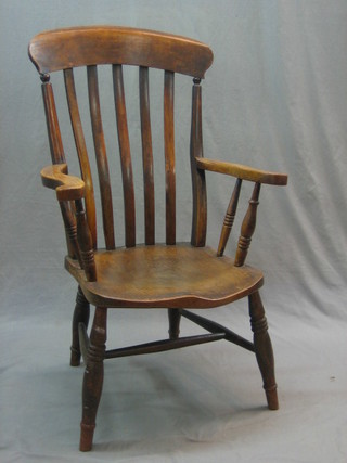 A 19th Century elm stick and bar back kitchen carver chair
