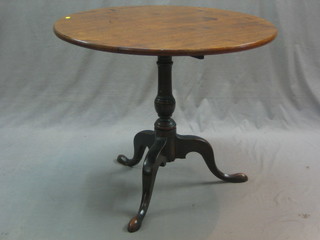 A 19th Century circular mahogany snap top tea table, raised on a turned column and tripod supports 32"