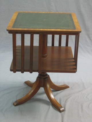 A Georgian style mahogany revolving coffee table/bookcase with green inset leather top, raised on  pillar and tripod supports 17"