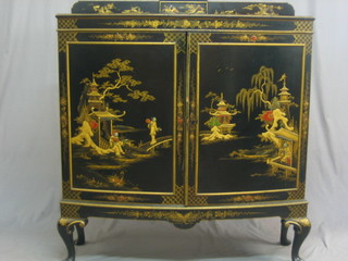 A 1930's bow front black lacquered chinoiserie cabinet enclosed by panelled doors on cabriole supports 42"