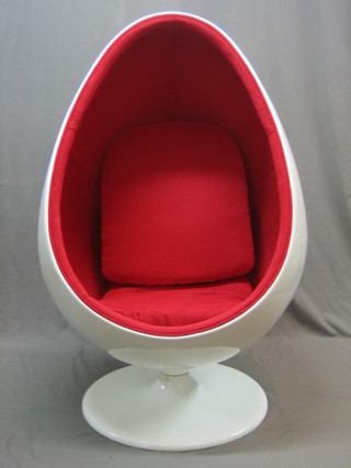 A white plastic reproduction Egg Chair, with red upholstered interior and 2 loose cushions