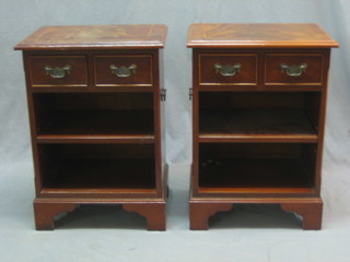 A pair of mahogany campaign style bedside cabinets, fitted 2 short drawers above adjustable shelves, raised on bracket feet 18"