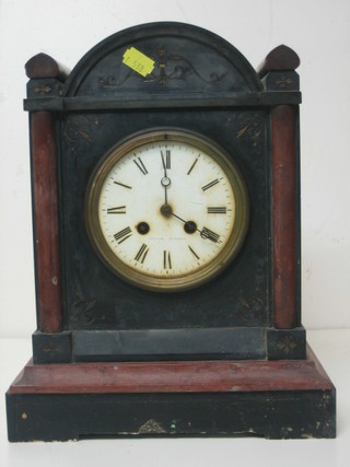 A Victorian French 8 day striking mantel clock with enamelled dial and Roman numerals contained in a 2 colour marble case