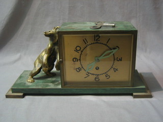 A Continental Art Deco mantel clock with square gilt dial contained in a bronze case, supported by a leaning bronze bear