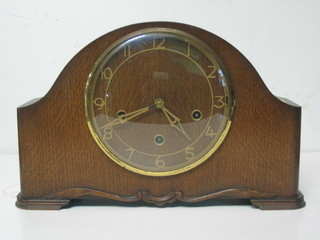 A 1930's chiming mantel clock with Arabic numerals contained in an oak arch shaped case by Smiths