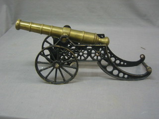 A childs 19th/20th Century brass barrelled canon with iron trunion (f)