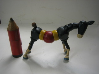 A childs wooden pencil in the form of a pencil 5" together with a wooden articulated model of a horse 5"