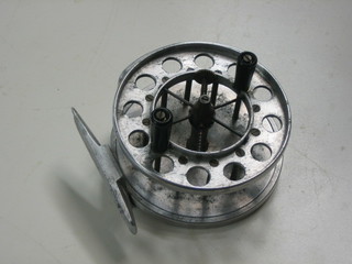 An Aerial centre pin fishing reel 3 1/2" with replacement back plate
