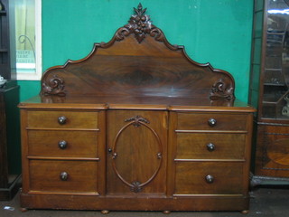 A Victorian mahogany inverted break front chiffonier with raised back, the base fitted a cupboard flanked by 6 long drawers with tore handles, raised on a platform base 71"