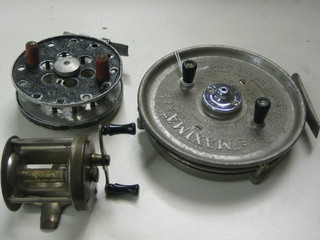 A Dowling centre pin fishing reel 4", a Shakespeare multiplying reel and a Maxima centre pin reel 5 1/2"