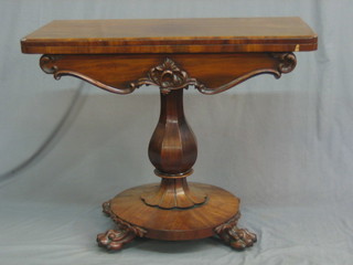 A Victorian mahogany D shaped card table raised on a turned column with circular base with paw feet 35"