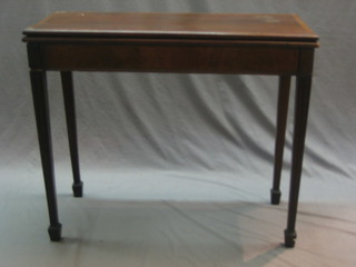 A 19th Century rectangular mahogany tea table with crossbanded top, raised on square supports ending in spade feet 36" (requires some attention)