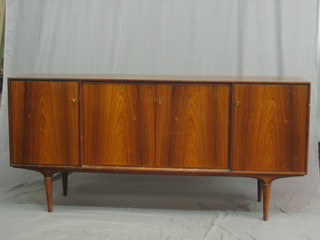 A 1960's/70's Swedish rosewood sideboard fitted 3 cupboards, raised on turned supports, the reverse marked Swedish design AB Stockholm 67"