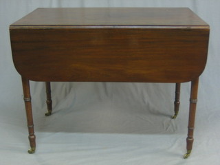 A 19th Century mahogany Pembroke table fitted a drawer, raised on turned supports, ending in brass caps and castors 36"